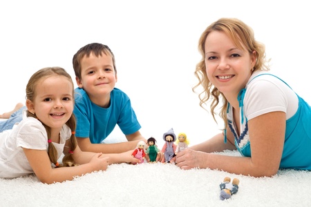 Happy woman and kids playing on the floor with puppets smiling - isolated Happy woman and kids playing on the floor with puppets smiling - isolated