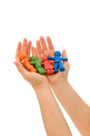 Hands holding colorful clay people - caring family concept, isolatedの写真素材