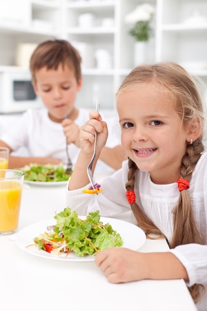 Kids in the kitchen eating healthy vegetables Kids in the kitchen eating healthy vegetables