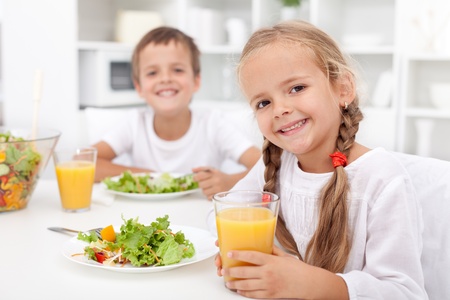 Kids eating a healthy meal in the kitchenの写真素材