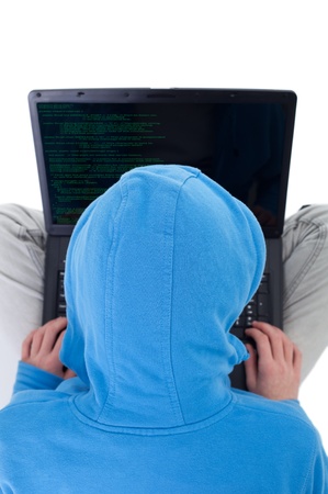 Young hacker with laptop and code fragment - top viewの写真素材