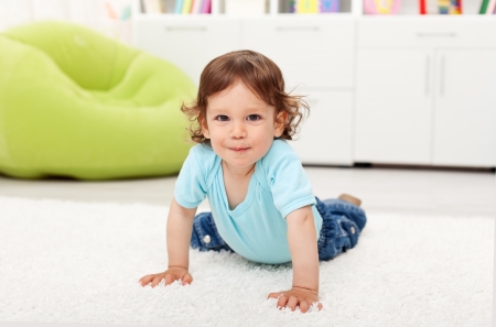 Beautiful toddler child - playing on the floor at homeの写真素材
