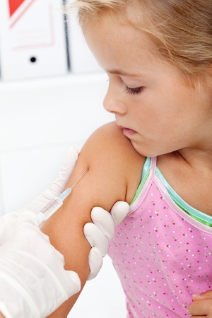 Little girl getting an injection or vaccine - closeupの写真素材