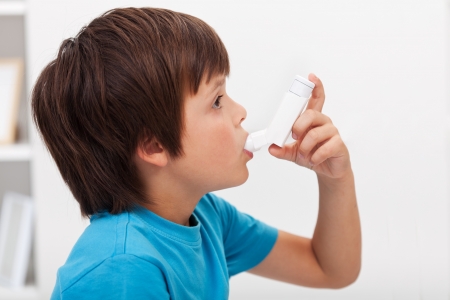 Boy using inhaler - respiratory system illnessの写真素材