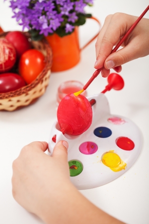 Child hands painting the easter eggs - closeupの写真素材