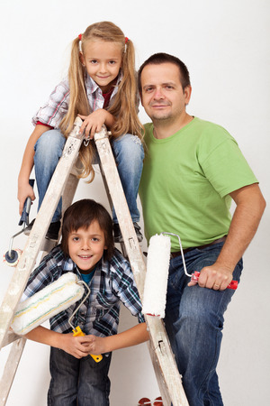 The painters task force - happy kids and their father with painting utensilsの写真素材