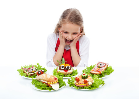 Little girl with creative party sandwiches - fresh food creatures, isolatedの写真素材