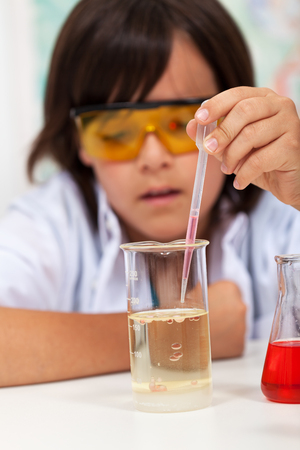 Elementary school boy doing the chemical yoyo experiment - closeupの写真素材