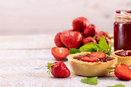 Delicious strawberry jam and dessert on rugged white wooden table - copy spaceの写真素材