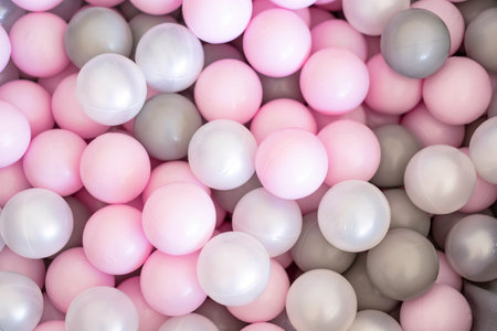 Playful pastel balls in pink, gray and white shades. Minimal, bright and soft background perfect for childrenâs themes, party design, banners, packaging and social media visualsの写真素材