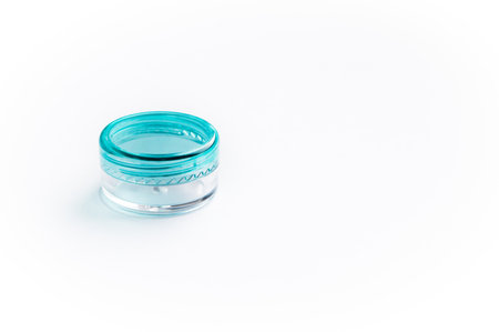 Empty small plastic or glass jar for beauty cream on whiteの写真素材