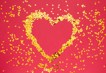 Gold heart with sparkles on red background. Valentines Day, International Womens Dayの写真素材