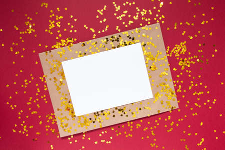 Envelope with white sheet of paper for message to loved one with tittle sparkles on red background with place for text. Happy Valentines day concept Flat lay International Women's Day Holiday Flatlayの写真素材