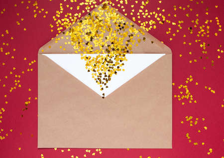 Envelope with white sheet of paper for message to loved one with tittle sparkles on red background with place for text. Happy Valentines day concept Flat lay International Women's Day Holiday Flatlayの写真素材