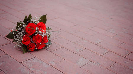beautiful bouquet of red rose lying on road, weddingの写真素材