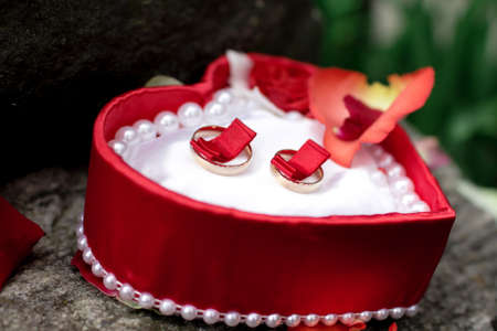 wedding rings lie neatly in a red box for weddingの写真素材