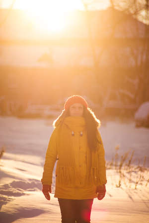 Portrait of romantic girl at sunset, sunrise, gold per hour on a frosty winter day,eveningの写真素材