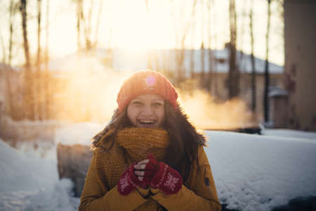 Portrait of romantic girl at sunset, sunrise, gold per hour on a frosty winter day,eveningの写真素材