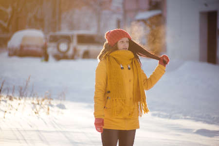 Portrait of romantic girl at sunset, sunrise, gold per hour on a frosty winter day,eveningの写真素材