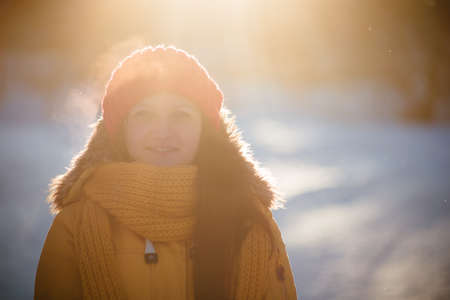 Portrait of romantic girl at sunset, sunrise, gold per hour on a frosty winter day,eveningの写真素材