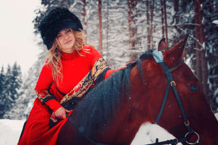 portrait of a beautiful girl and a handsome stallion, a horse in the winter on the nature, styleの写真素材