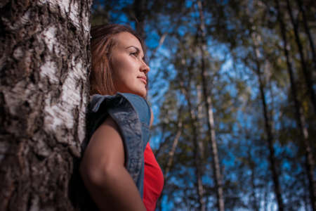 portrait of the charming girl in the fresh air, sun, summerの写真素材
