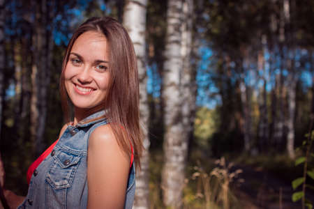 portrait of the charming girl in the fresh air, sun, summerの写真素材