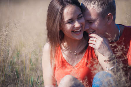 the loving couple walks on the wheat field, love storyの写真素材