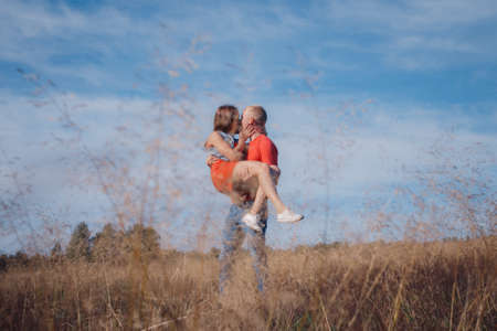 the loving couple walks on the wheat field, love storyの写真素材