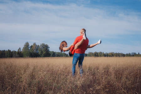 the loving couple walks on the wheat field, love storyの写真素材