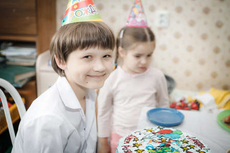 brother and sister sitting at home cakeの写真素材