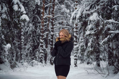 walks outdoors: the girl walks on the winter forestの写真素材