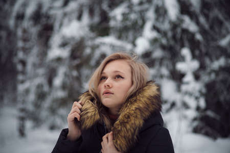 walks outdoors: the girl walks on the winter forestの写真素材