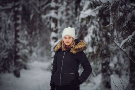 walks outdoors: the girl walks on the winter forestの写真素材