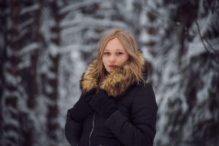 walks outdoors: the girl walks on the winter forestの写真素材