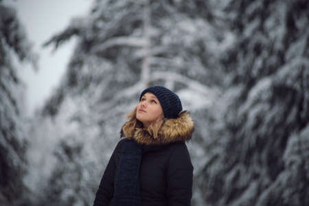 walks outdoors: the girl walks on the winter forestの写真素材