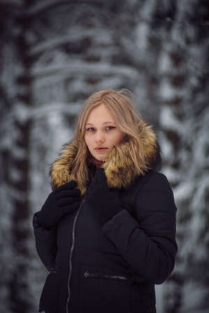walks outdoors: the girl walks on the winter forestの写真素材