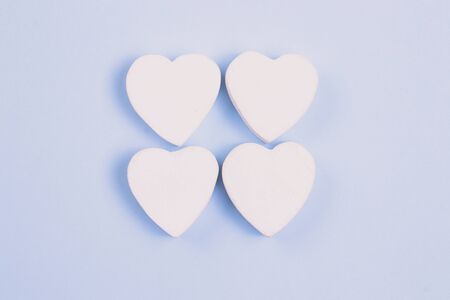 Four white heart on a pastel blue background. Love concept for your design.の写真素材