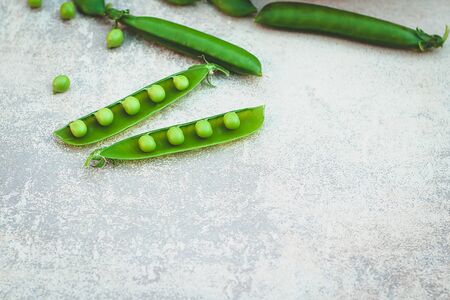 Sweet green peas on a grey background.の写真素材