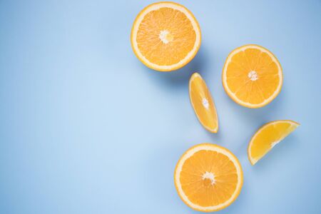 Pieces of citrus on a blue background.の写真素材