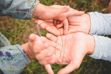 Hands of the mother and kid. Charming concept.の写真素材