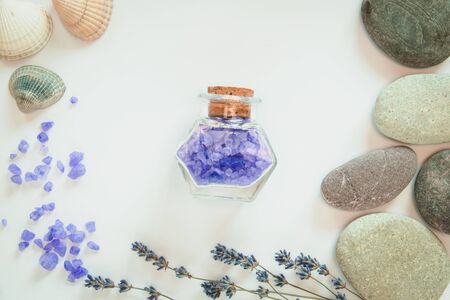 Spa concept. Fowers of lavender, decorative bottles, seashells and stone on the white background. Relaxing concept. Isolated.の写真素材