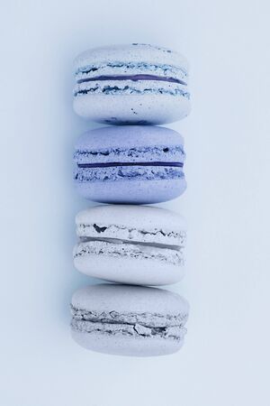 Fresh blue-colored macarons on a flat lay blue background. Shades of blue colors. French dessert. Flat lay.の写真素材