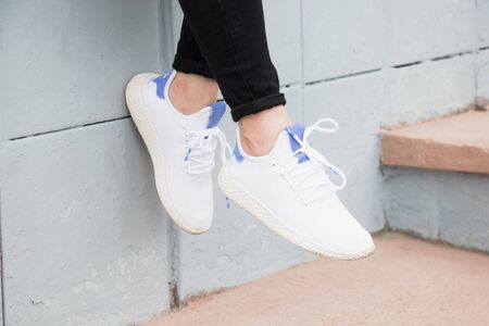 White sneakers on the girl on her legs. Image for design.の写真素材