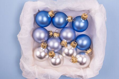A lot of different matte blue balls in a box. Christmas and New Year concept.の写真素材