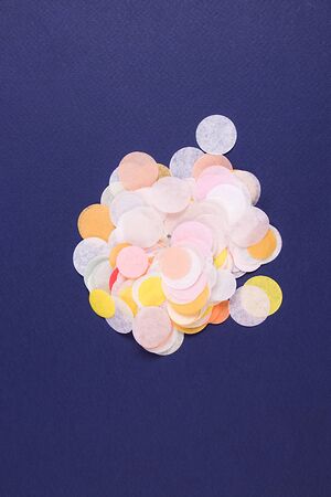 Colorful confetti on the middle of the blue background. Holiday concept.の写真素材