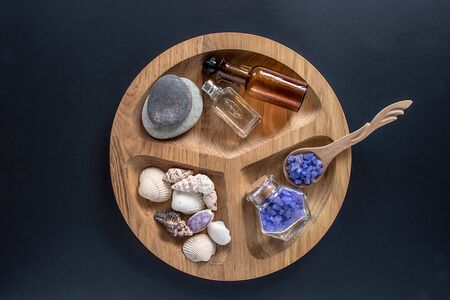 Seshels and seastones, bottles, lavender salts on the wooden round form.の写真素材