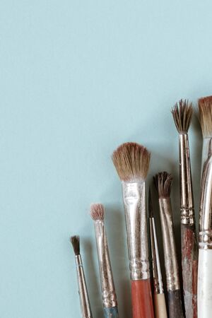 Old brushes for painting on a blue flat lay. Flat lay.の写真素材