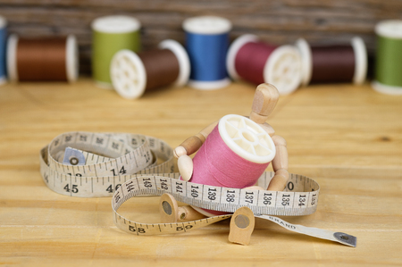 Sewing Supplies on Wood Background,Tape measure , scissors, bobbinの写真素材