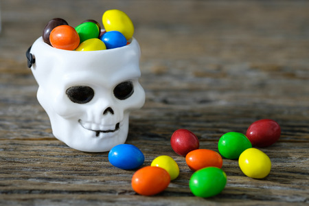 Candy colors contained in the tank white cranium skull.の写真素材